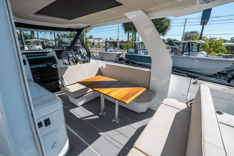 Slide: The Image of Interior of 2025 Quarken 35 Sport Tourer, featuring modern seating and wooden table. - 16