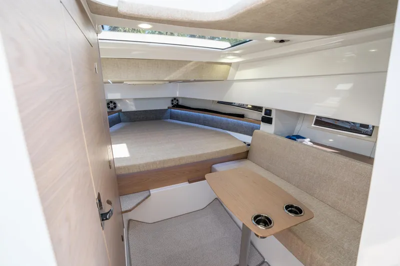 Slide: The Image of 2025 Quarken 35 Sport Tourer cabin interior with seating and table. - 35