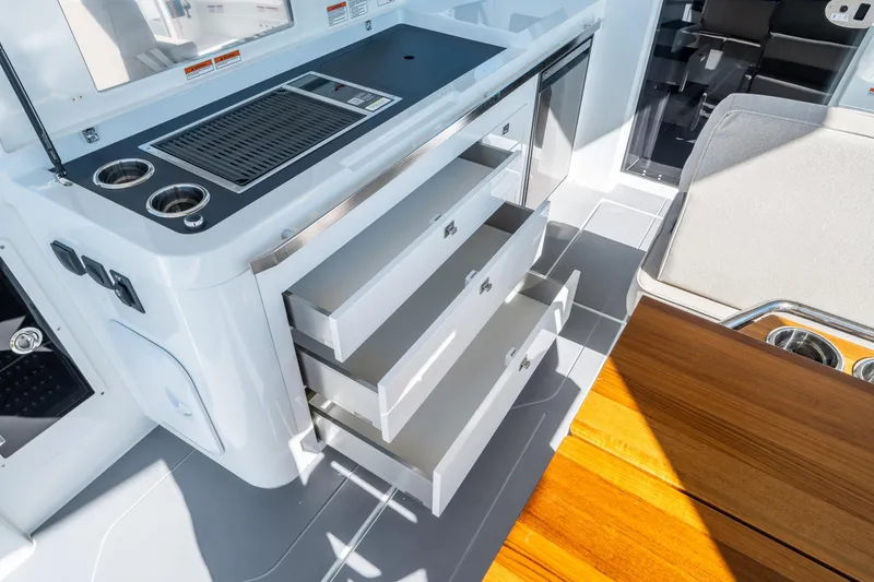 Slide: The Image of Interior of 2025 Quarken 35 Sport Tourer showing open drawers and sleek design. - 21