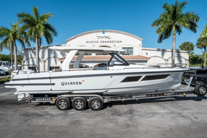 Slide: The Image of 2025 Quarken 35 Sport Tourer boat on trailer at Marine Connection dealership. - 1