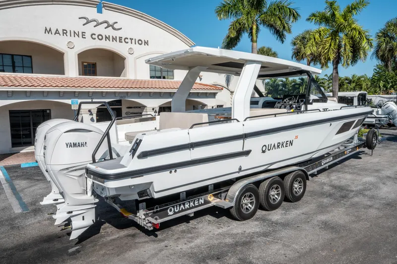 Slide: The Image of 2025 Quarken 35 Sport Tourer boat on trailer at Marine Connection dealership. - 2