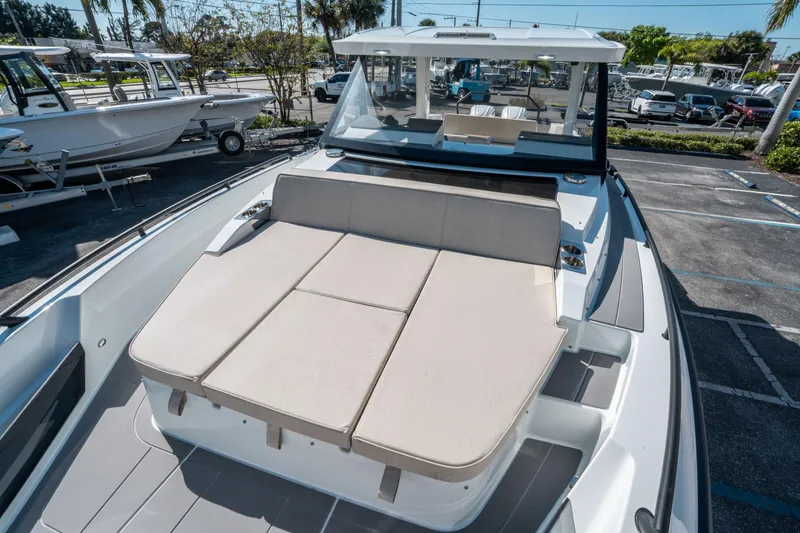 Slide: The Image of 2025 Quarken 35 Sport Tourer with sunbed, parked in a marina setting. - 30