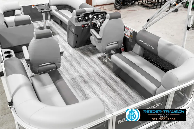 Slide: The Image of 2025 Bennington 21 SSR pontoon boat interior with gray seating and modern dashboard. - 15