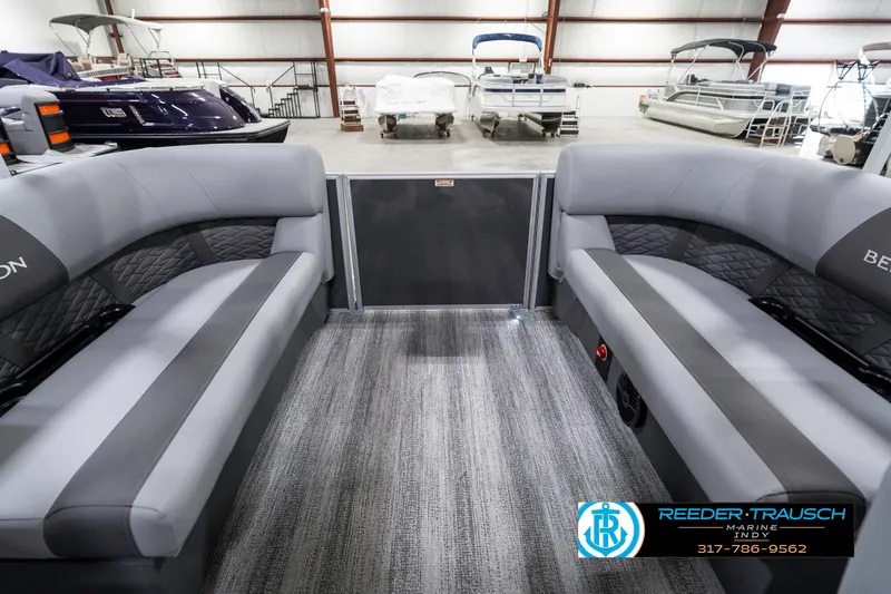 Slide: The Image of 2025 Bennington 21 SSR interior with gray seating in a showroom. - 18