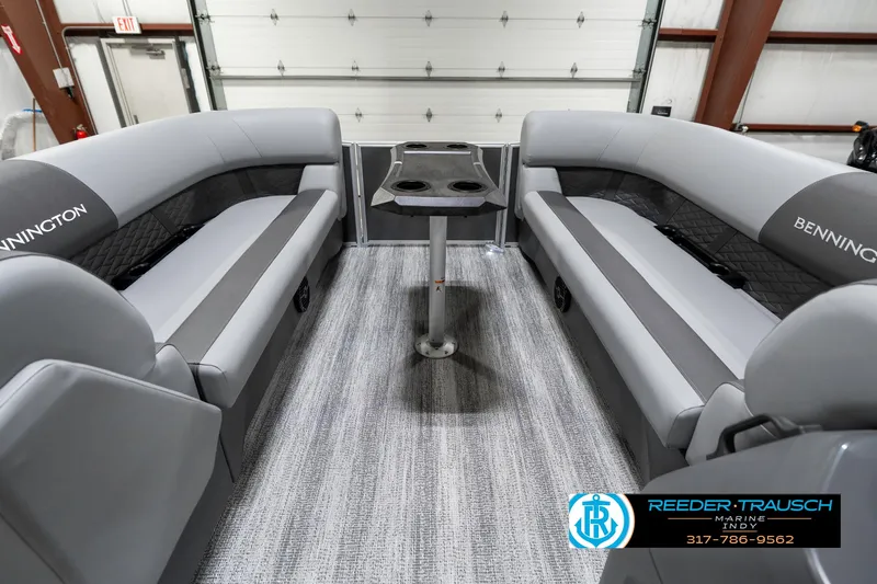 Slide: The Image of 2025 Bennington 21 SSR boat interior with gray seating and central table. - 21
