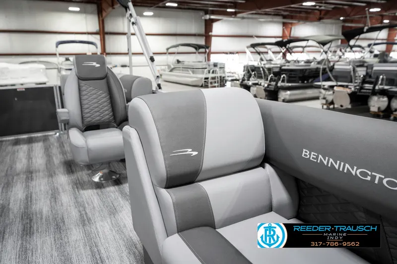 Slide: The Image of 2025 Bennington 21 SSR boat interior with gray seating in showroom. - 24