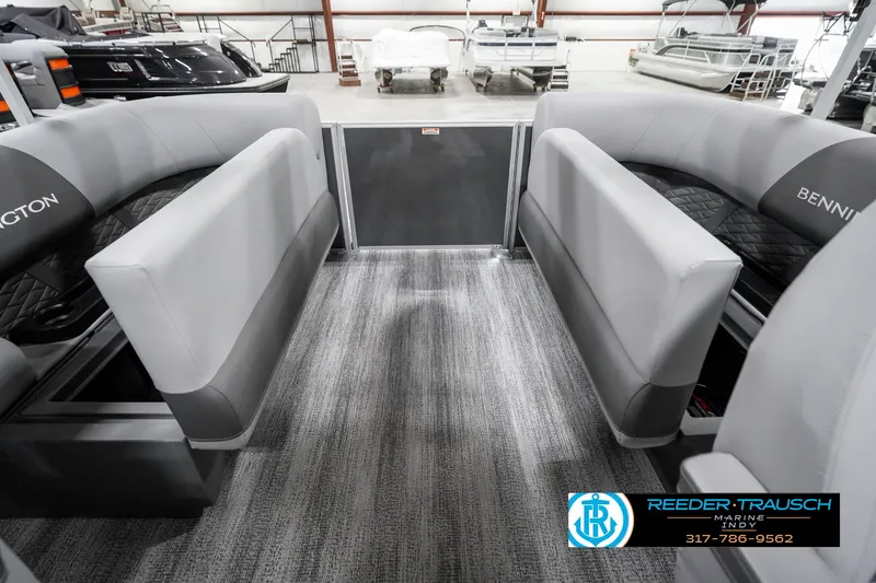 Slide: The Image of 2025 Bennington 21 SSR pontoon boat interior with gray seating and carpet flooring. - 27