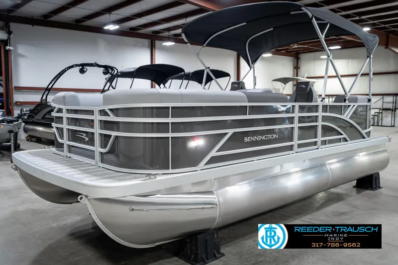 Slide: The Image of 2025 Bennington 21 SSR pontoon boat in showroom, featuring sleek design and canopy. - 3