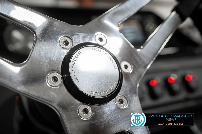 Slide: The Image of Steering wheel of 2025 Bennington 21 SSR boat, featuring metallic design and logo. - 30