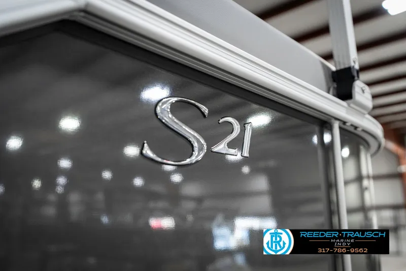 Slide: The Image of 2025 Bennington 21 SSR boat with "S21" emblem in a showroom. - 48