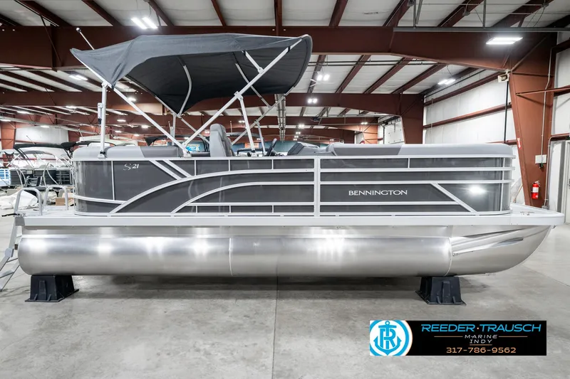 Slide: The Image of 2025 Bennington 21 SSR pontoon boat in showroom, side view with canopy. - 7