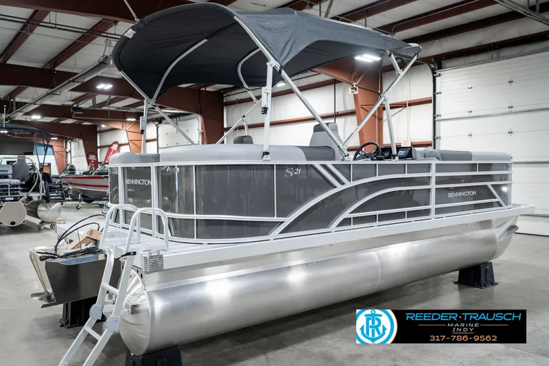 Slide: The Image of 2025 Bennington 21 SSR pontoon boat in showroom with canopy and sleek design. - 8