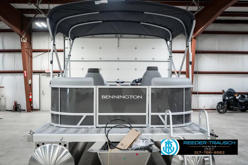 Slide: The Image of 2025 Bennington 21 SSR pontoon boat in a warehouse setting. - 9