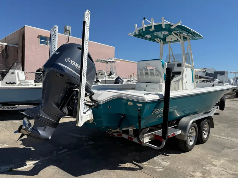 Slide: The Image of 2018 Pathfinder 2600 TRS boat with Yamaha engine on a trailer, parked outdoors. - 15