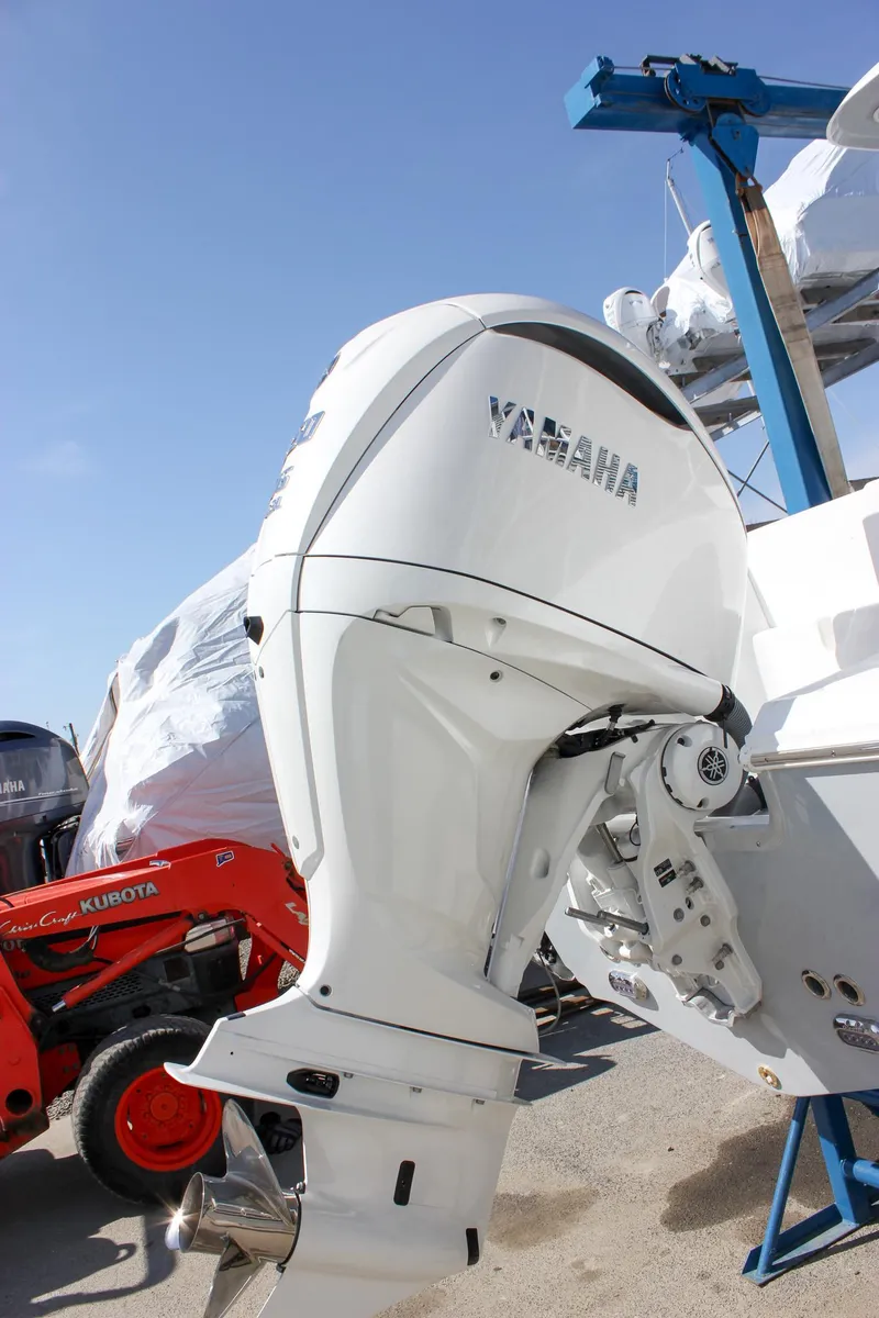 Slide: The Image of Outboard motor on a 2025 Sea Hunt Ultra 255 SE boat, with clear blue sky. - 11