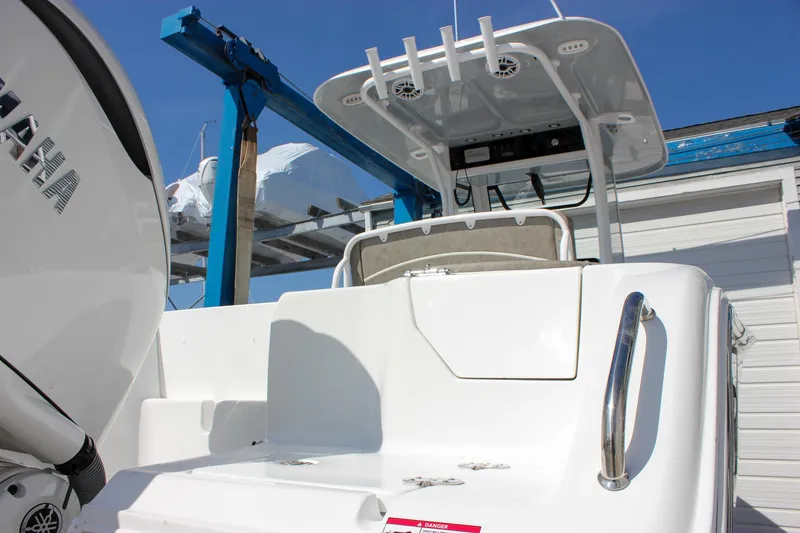 Slide: The Image of 2025 Sea Hunt Ultra 255 SE boat, rear view, showcasing deck and seating area. - 12