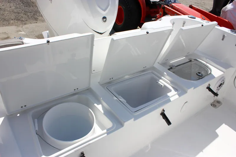 Slide: The Image of 2025 Sea Hunt Ultra 255 SE boat storage compartments open for viewing. - 16
