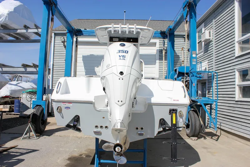 Slide: The Image of 2025 Sea Hunt Ultra 255 SE boat with 350 V6 engine in a boatyard. - 2