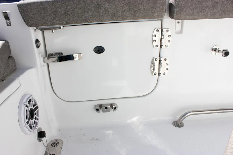 Slide: The Image of 2025 Sea Hunt Ultra 255 SE boat interior, featuring storage compartment and speaker. - 20