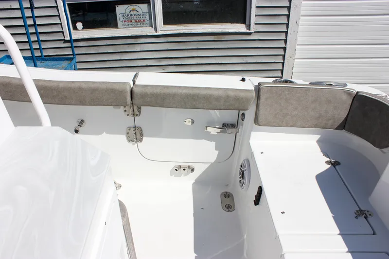 Slide: The Image of 2025 Sea Hunt Ultra 255 SE boat interior with cushioned seating and storage compartments. - 22