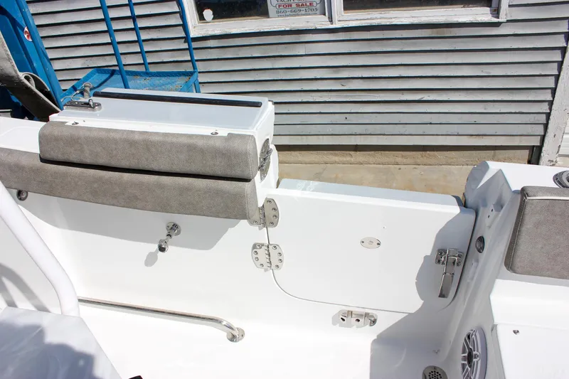 Slide: The Image of 2025 Sea Hunt Ultra 255 SE boat interior with seating and storage compartments. - 23