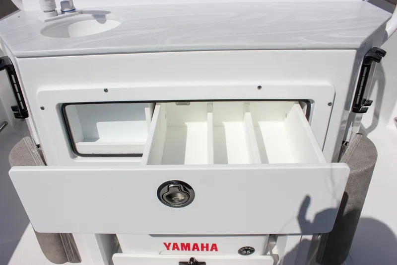 Slide: The Image of 2025 Sea Hunt Ultra 255 SE boat storage compartment with Yamaha branding. - 25