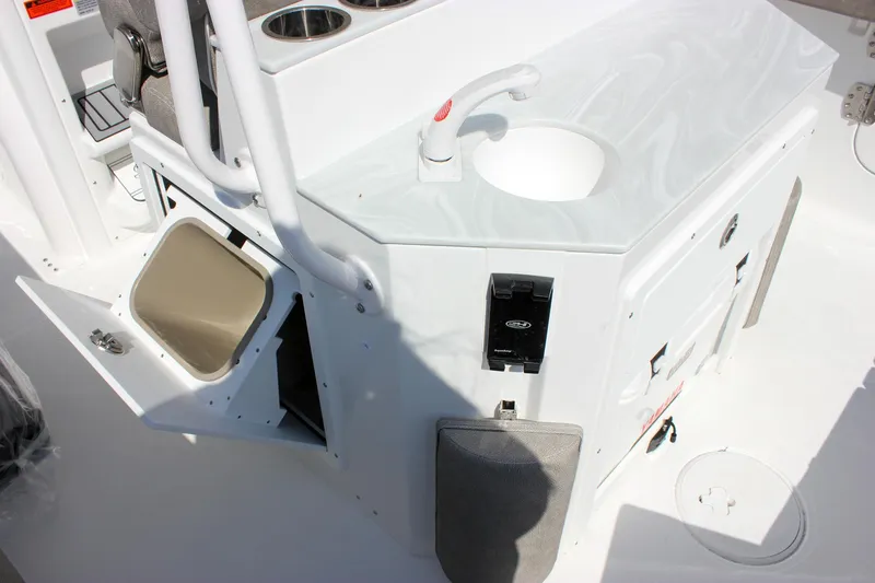Slide: The Image of 2025 Sea Hunt Ultra 255 SE boat interior with sink and storage compartments. - 27