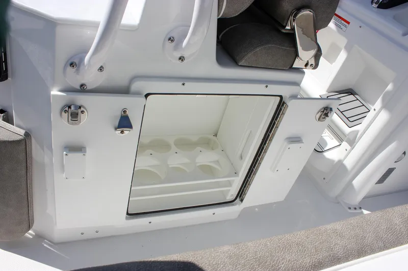 Slide: The Image of 2025 Sea Hunt Ultra 255 SE boat interior storage compartment with open door. - 28