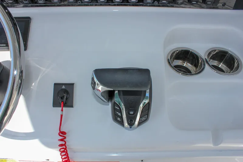 Slide: The Image of Control panel of 2025 Sea Hunt Ultra 255 SE boat with throttle and cup holders. - 32