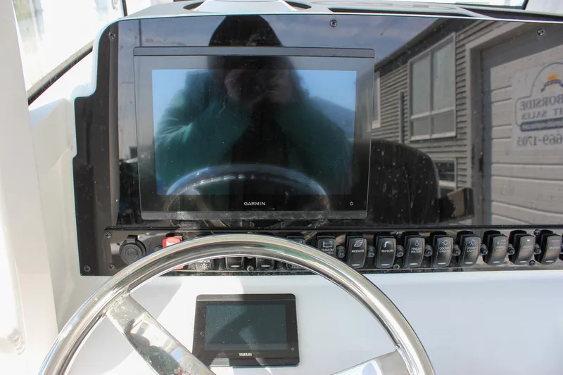 Slide: The Image of Dashboard of 2025 Sea Hunt Ultra 255 SE boat with Garmin display and controls. - 34