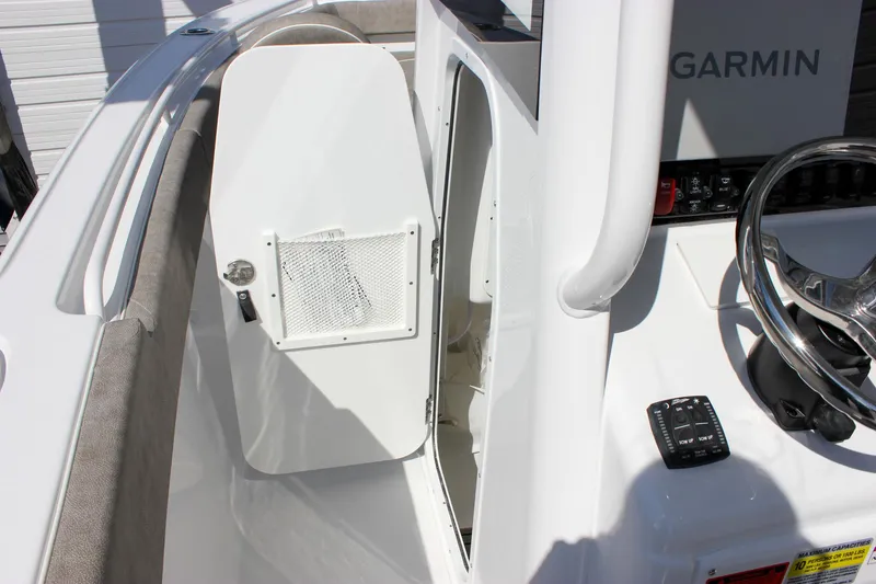 Slide: The Image of 2025 Sea Hunt Ultra 255 SE boat console with Garmin electronics and storage compartment. - 39