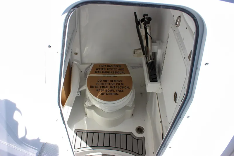 Slide: The Image of 2025 Sea Hunt Ultra 255 SE boat storage compartment with safety instructions. - 40