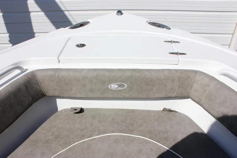 Slide: The Image of 2025 Sea Hunt Ultra 255 SE boat interior with cushioned seating and storage compartment. - 46