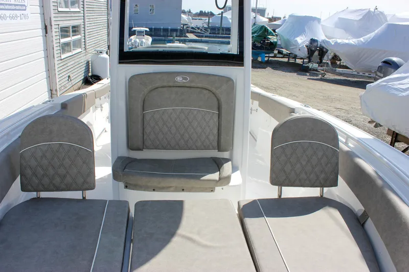 Slide: The Image of 2025 Sea Hunt Ultra 255 SE boat interior with cushioned seating and storage compartments. - 48