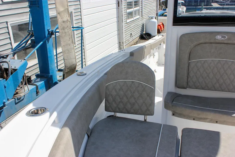 Slide: The Image of 2025 Sea Hunt Ultra 255 SE boat interior with gray cushioned seating. - 50
