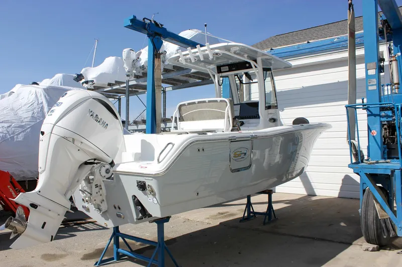 Slide: The Image of 2025 Sea Hunt Ultra 255 SE boat on a lift, featuring a Yamaha outboard motor. - 9
