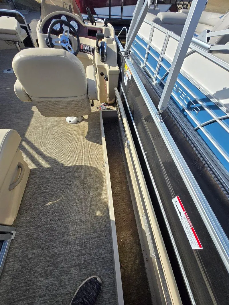 Slide: The Image of 2018 Misty Harbor 2085 Adventure CF boat interior with steering wheel and seating. - 2