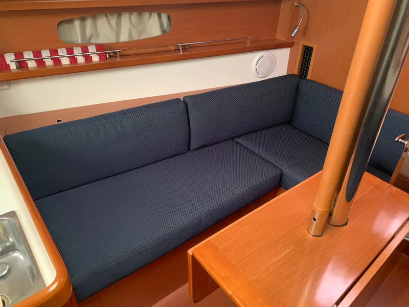 Slide: The Image of Interior of 2010 Beneteau Oceanis 31 sailboat with blue cushioned seating. - 12