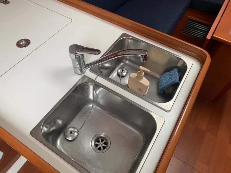 Slide: The Image of Galley sink area in 2010 Beneteau Oceanis 31 yacht with dual basins and faucet. - 18