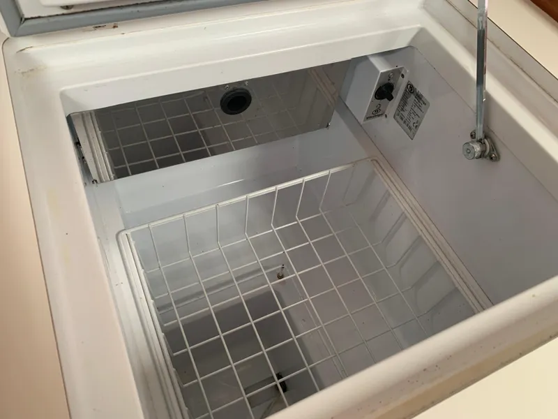 Slide: The Image of Open storage compartment on 2010 Beneteau Oceanis 31 yacht, featuring a wire basket. - 19