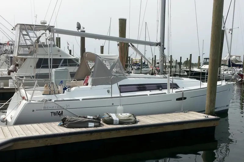 Slide: The Image of 2010 Beneteau Oceanis 31 sailboat docked at a marina, side view. - 2