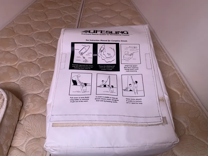 Slide: The Image of Lifesling safety device on Beneteau Oceanis 31, 2010, with instructional manual on mattress. - 22