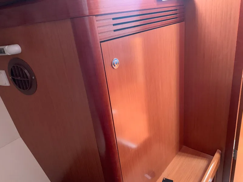 Slide: The Image of Wooden interior of 2010 Beneteau Oceanis 31 sailboat, featuring a cabinet and vent. - 26