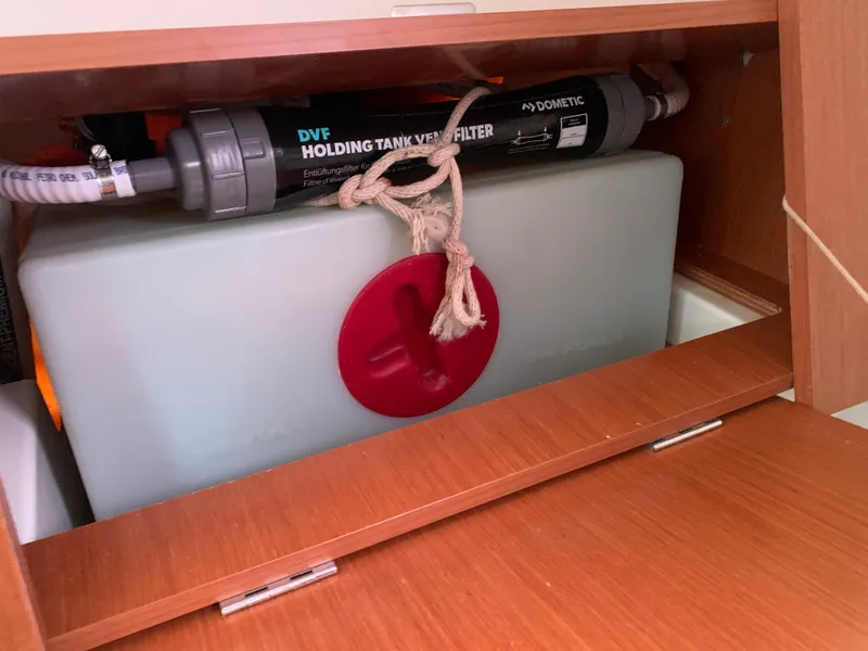 Slide: The Image of Beneteau Oceanis 31 (2010) holding tank with Dometic vent filter in wooden cabinet. - 32
