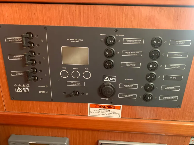Slide: The Image of Control panel of a 2010 Beneteau Oceanis 31 sailboat, featuring various switches and indicators. - 33