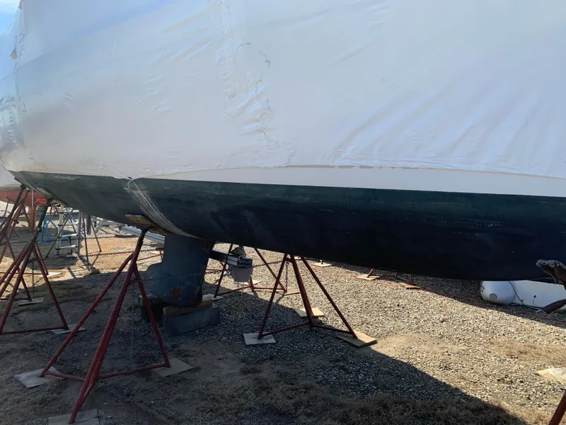 Slide: The Image of 2010 Beneteau Oceanis 31 sailboat on stands, hull view, outdoor setting. - 40