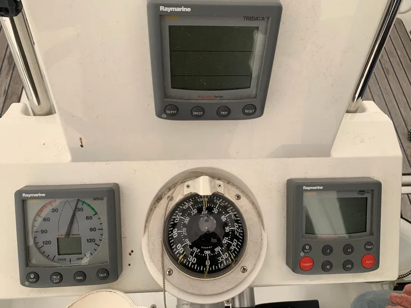 Slide: The Image of Beneteau Oceanis 31 2010 cockpit instruments, featuring Raymarine displays and compass. - 42