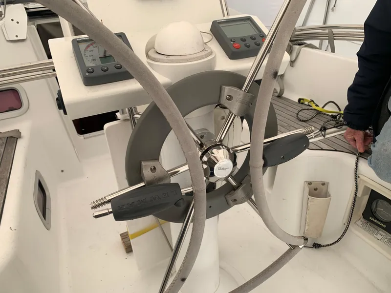 Slide: The Image of Steering wheel and controls of a 2010 Beneteau Oceanis 31 sailboat cockpit. - 45