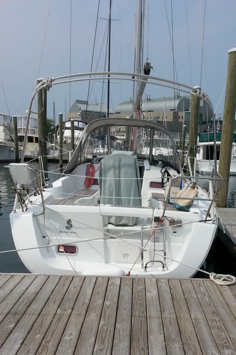 Slide: The Image of 2010 Beneteau Oceanis 31 sailboat docked at a marina, rear view. - 5
