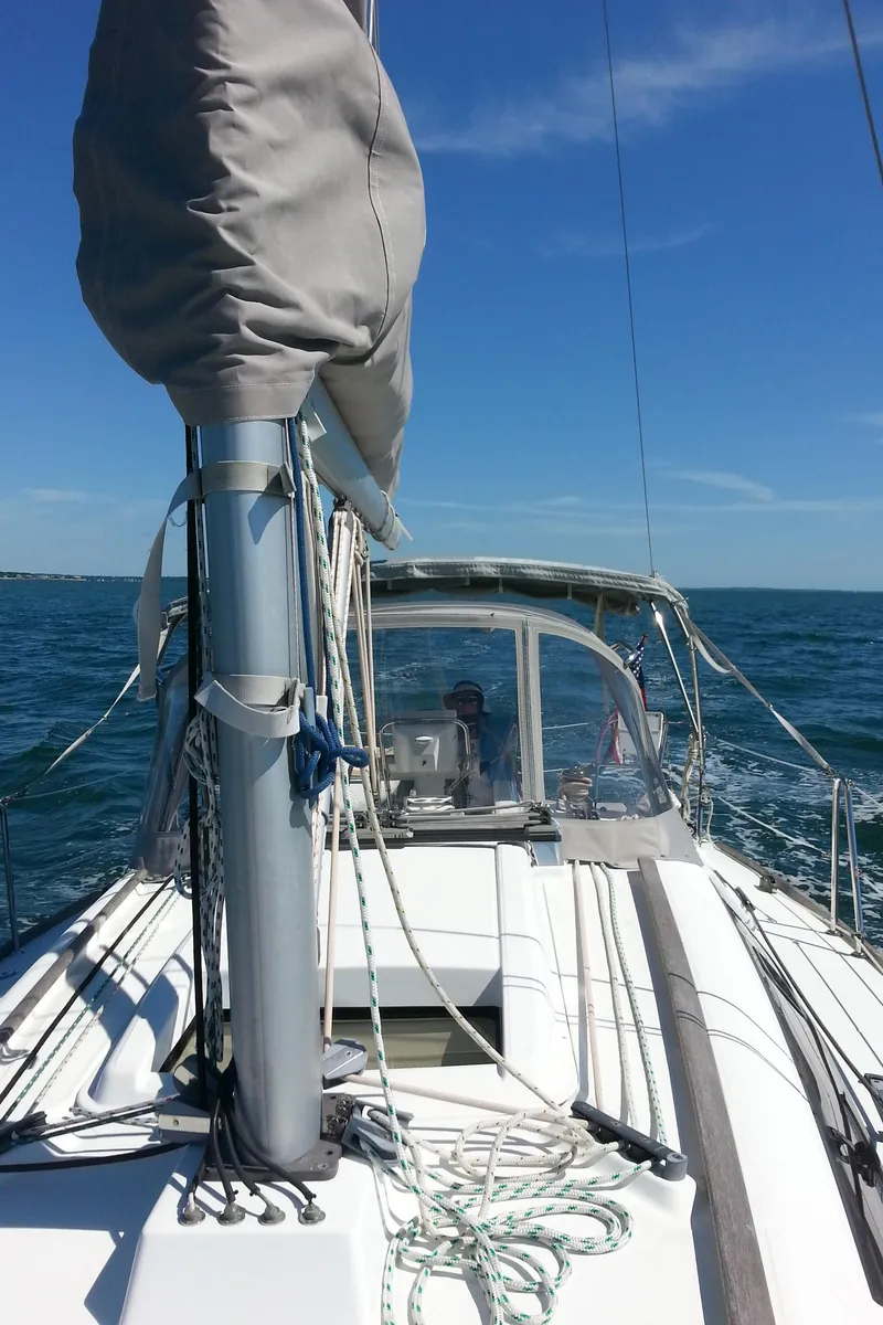 Slide: The Image of 2010 Beneteau Oceanis 31 sailboat on open sea under clear blue sky. - 6